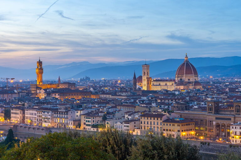 Panoramic dusk view of Florence skyline featuring Brunelleschi's Dome, Giotto's Campanile, and Palazzo Vecchio under a soft twilight sky during a Baroque Bacchus tour